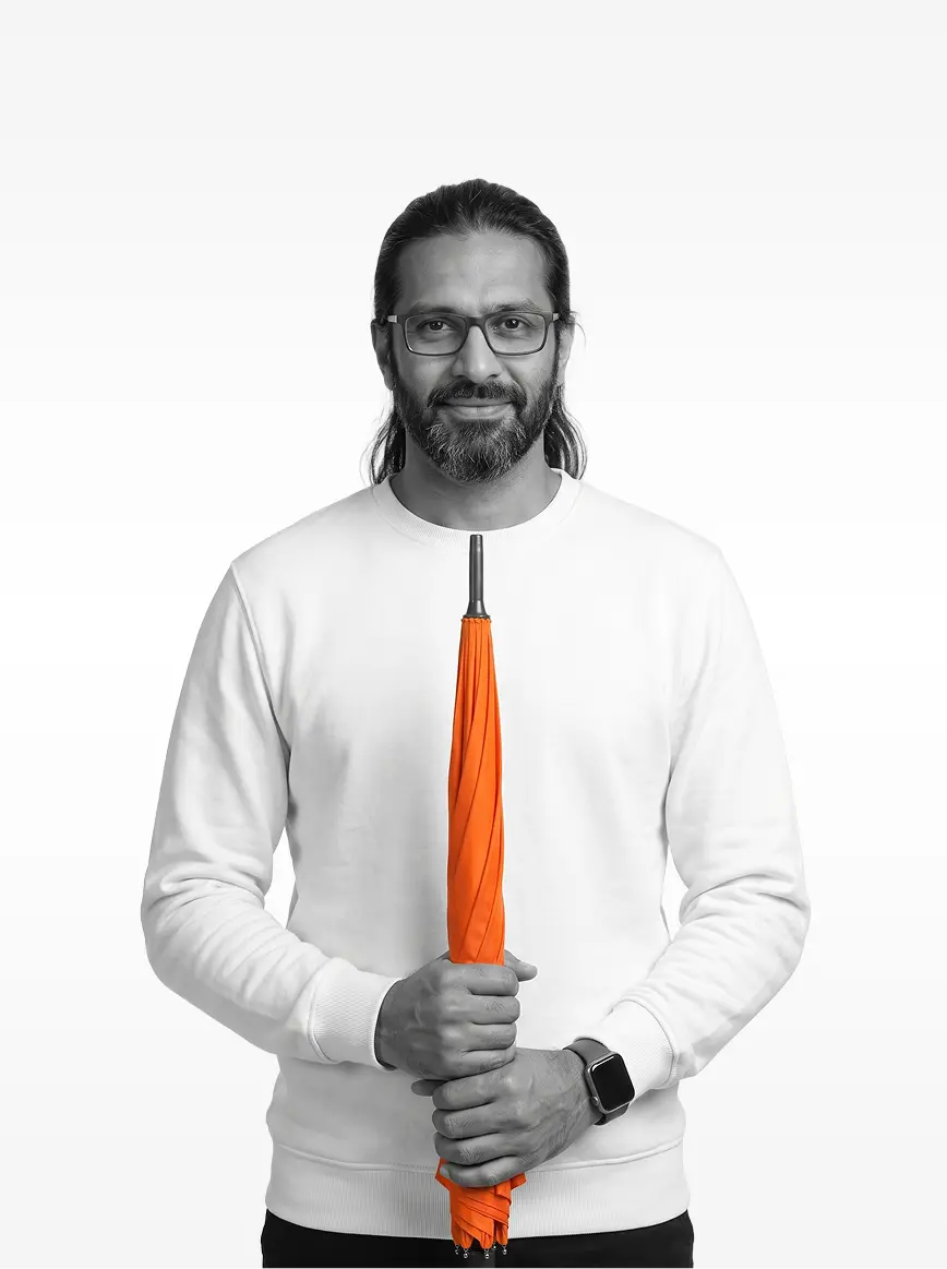 Ahmed Nasser holding a closed orange umbrella upright
