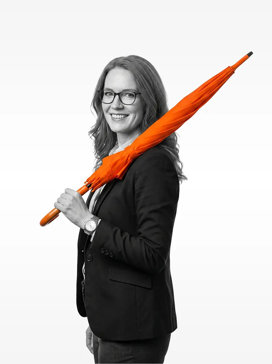 Clarke Bennett with a closed orange umbrella resting over one shoulder