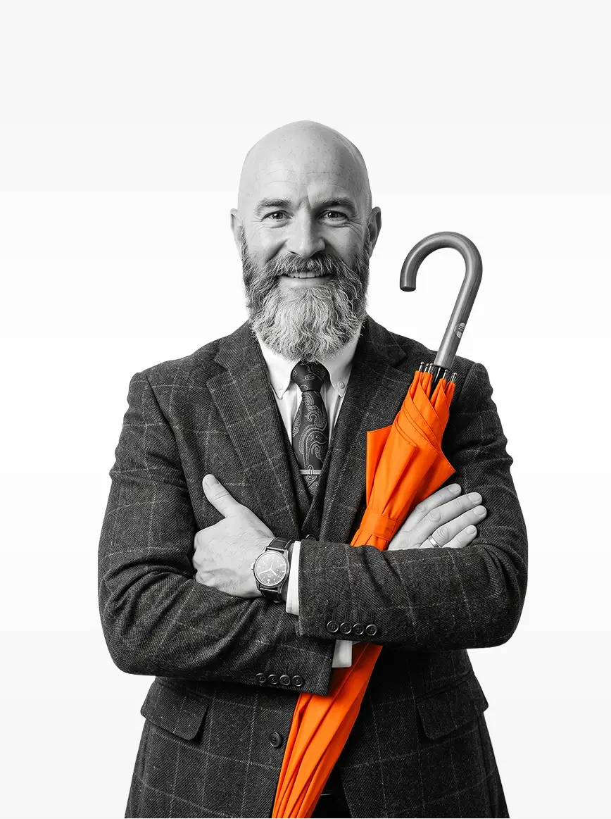 Jeorge Halloran, arms crossed, holding a closed orange umbrella